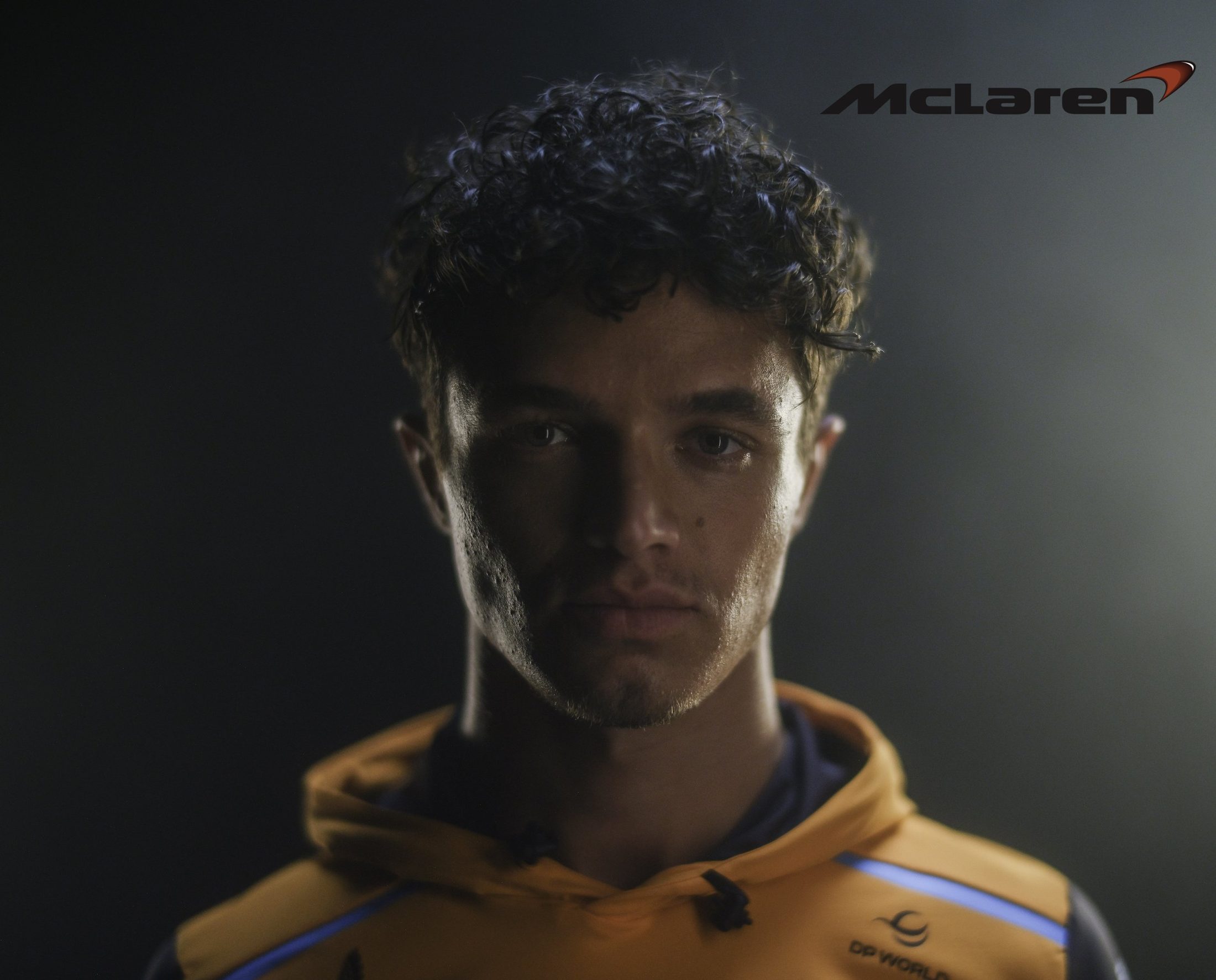 Lando Norris lit against black, McLaren