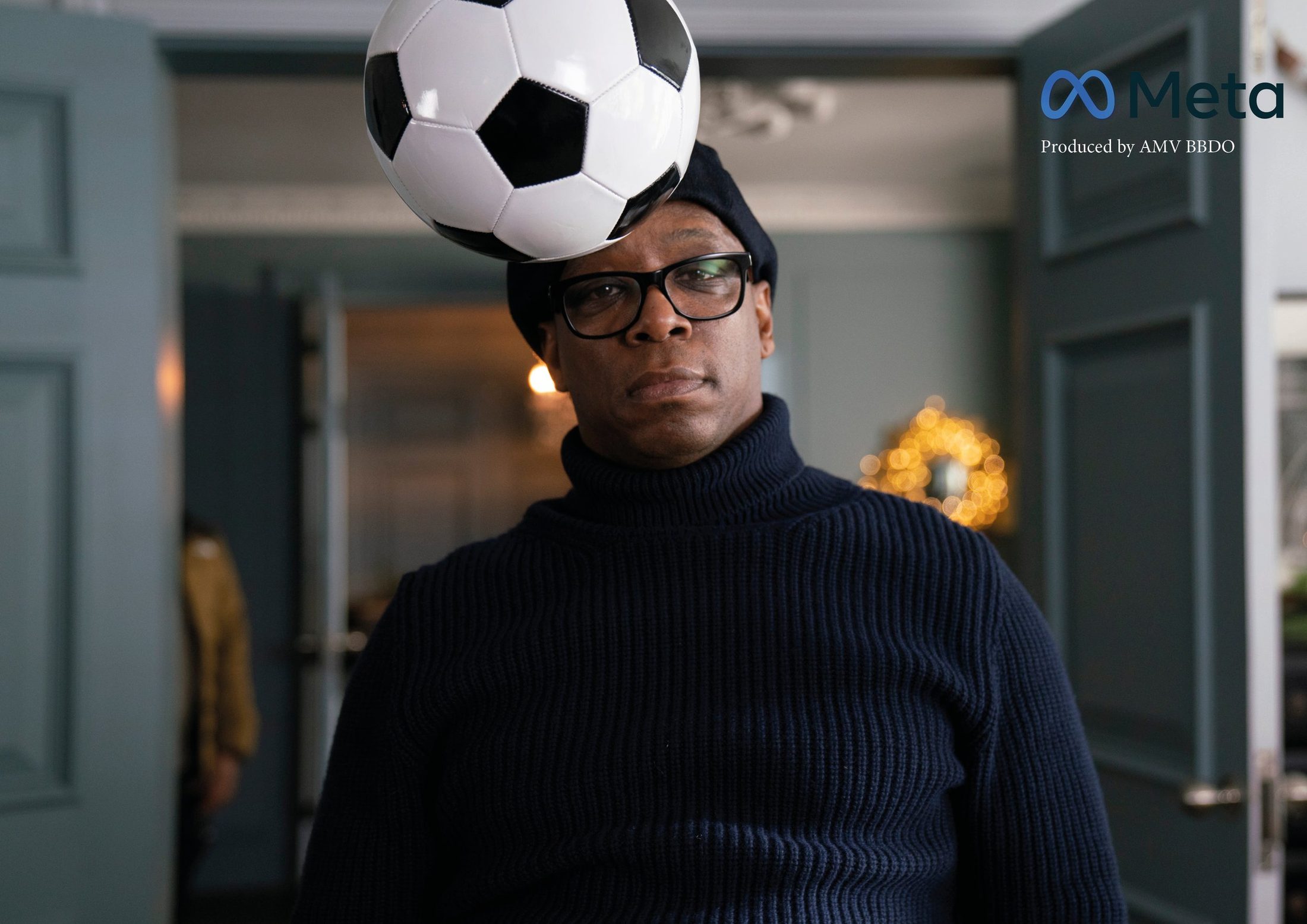 A man with a football balanced on his head, Meta