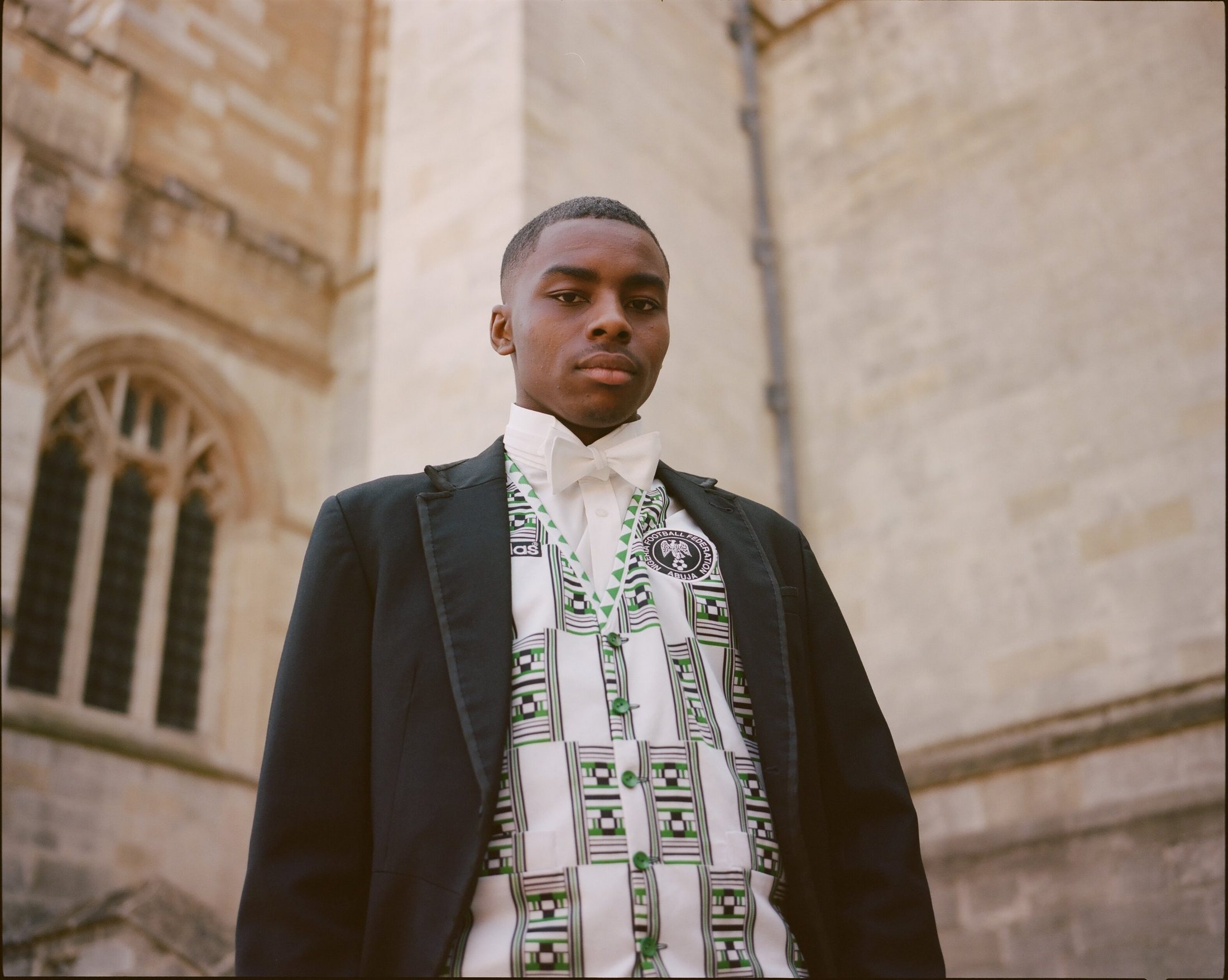 Young chorister in vestments outside a cathedral