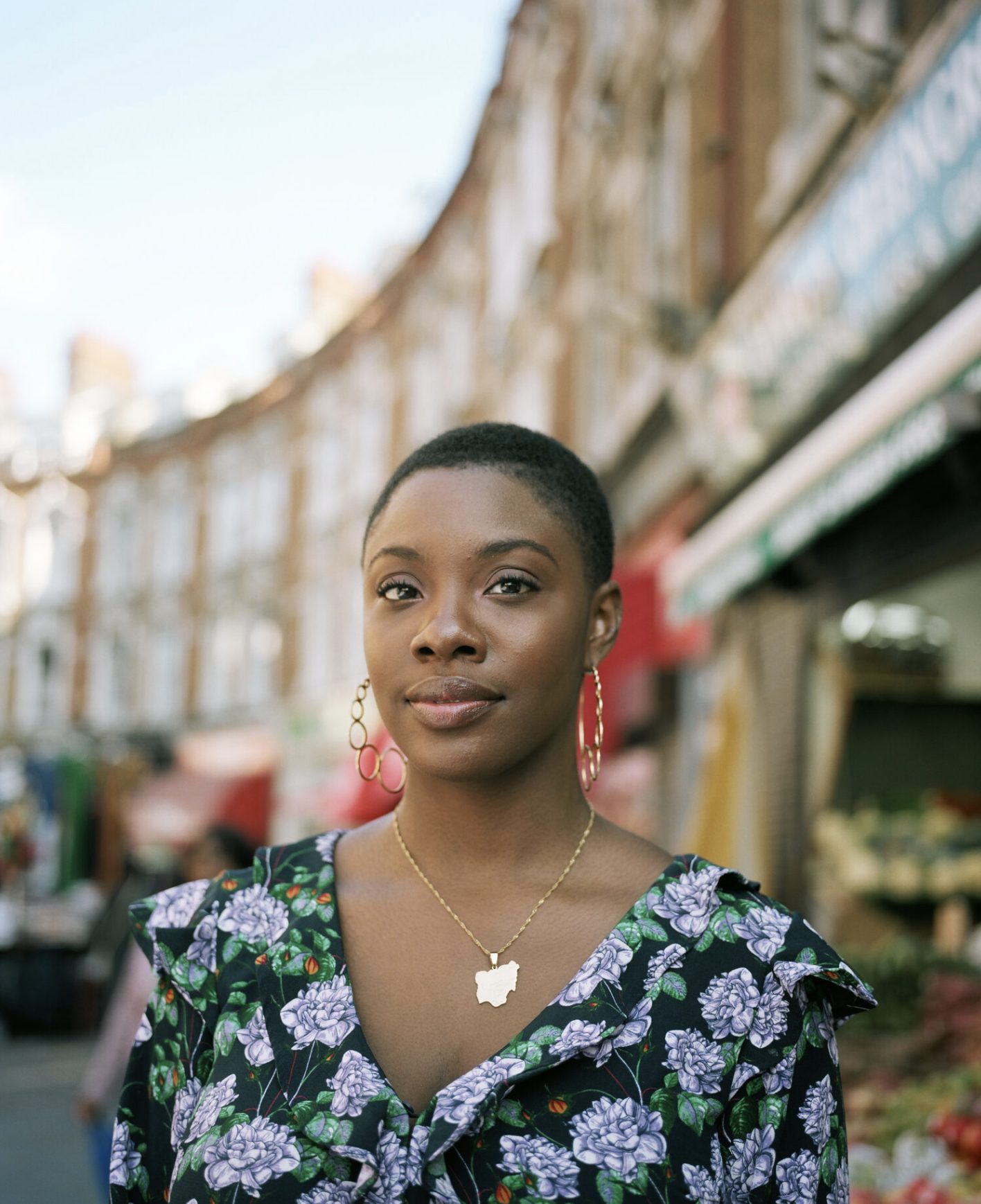 Woman in a floral dress on a London street at dusk