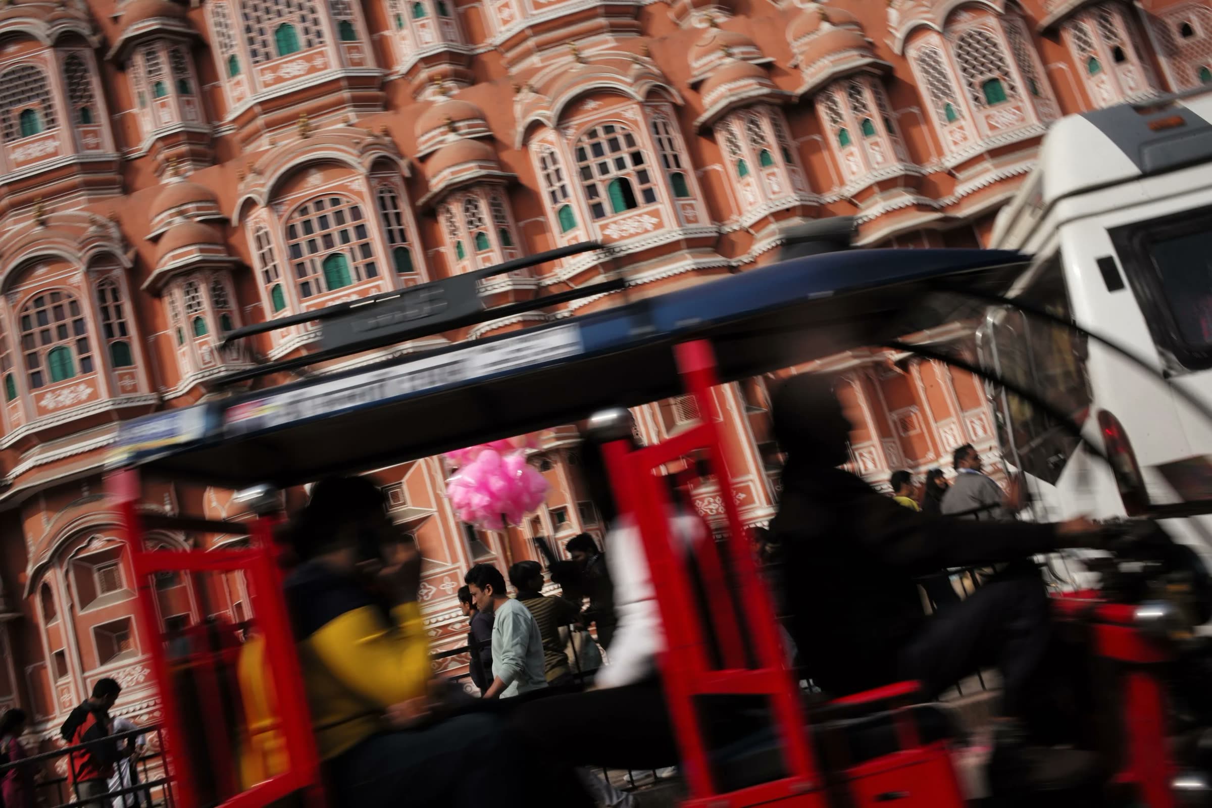 An auto-rickshaw sweeping past the Hawa Mahal, Jaipur